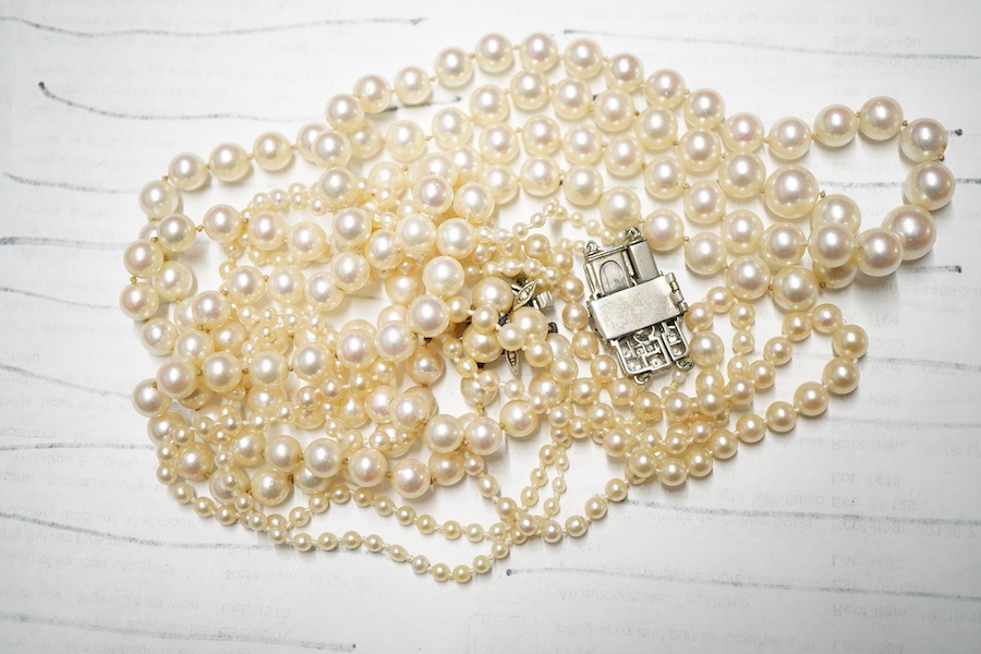 Two double strand cultured pearl necklaces, one graduated with paste set white metal clasp, 48cm, the other with cultured pearl set 9ct white gold clasp.